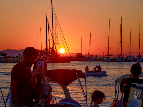 A Couple Taking a Selfie while on a Boat during the Golden Hour