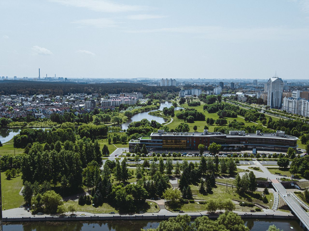 Expansive urban cityscape blending modern architecture and lush green parks