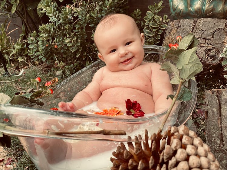 A Baby In Bathtub With Flowers