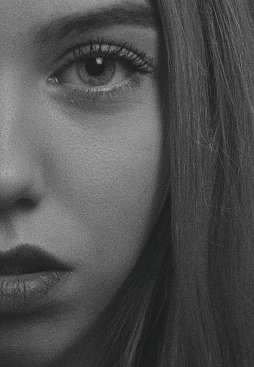 Free Striking black and white close-up portrait of a woman's face, highlighting her eye and lips. Stock Photo