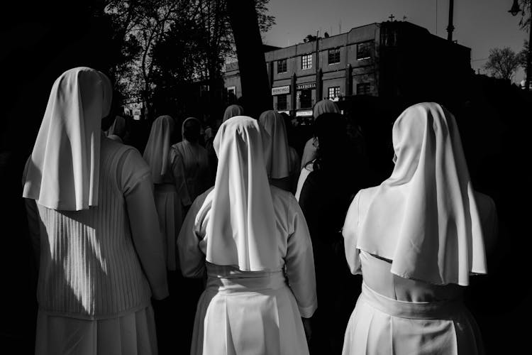 Group Of Nuns Standing Before Building