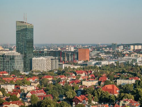 Free An aerial view of a modern urban skyline with residential and commercial buildings under a clear sky. Stock Photo