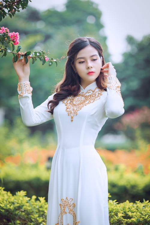 Selective Focus Photography Of Woman Holding Tree Leaves