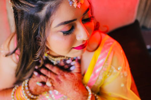 Young Woman Wearing a Saree, Jewelry and Henna Tattoos