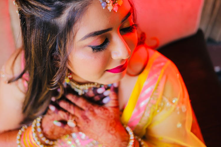 Young Woman Wearing A Saree, Jewelry And Henna Tattoos