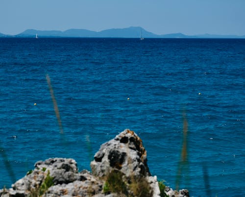 Panorama of a Sea Bay with a Distant Mountains on the Horizon