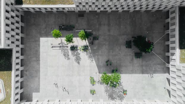 An aerial view showcasing the modern architecture of a courtyard with green spaces in Viganello, Switzerland.