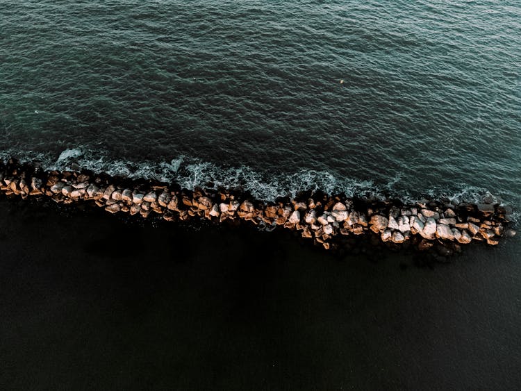 Waves Splashing On Rocks On Beach