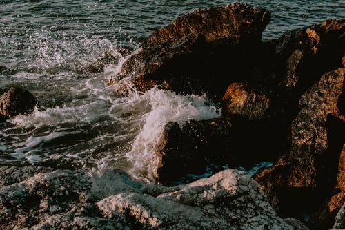 Free Dramatic scene of waves splashing against rugged rocks in Bellaria, Emilia-Romagna, Italy. Stock Photo