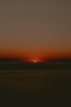 A tranquil sunset with warm hues over the Adriatic Sea at Igea Marina, Italy.