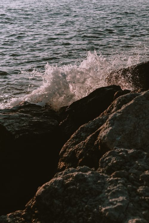 Free Dynamic shot of waves crashing against the rocks at Bellaria Beach, capturing the beauty of the sea during the day. Stock Photo