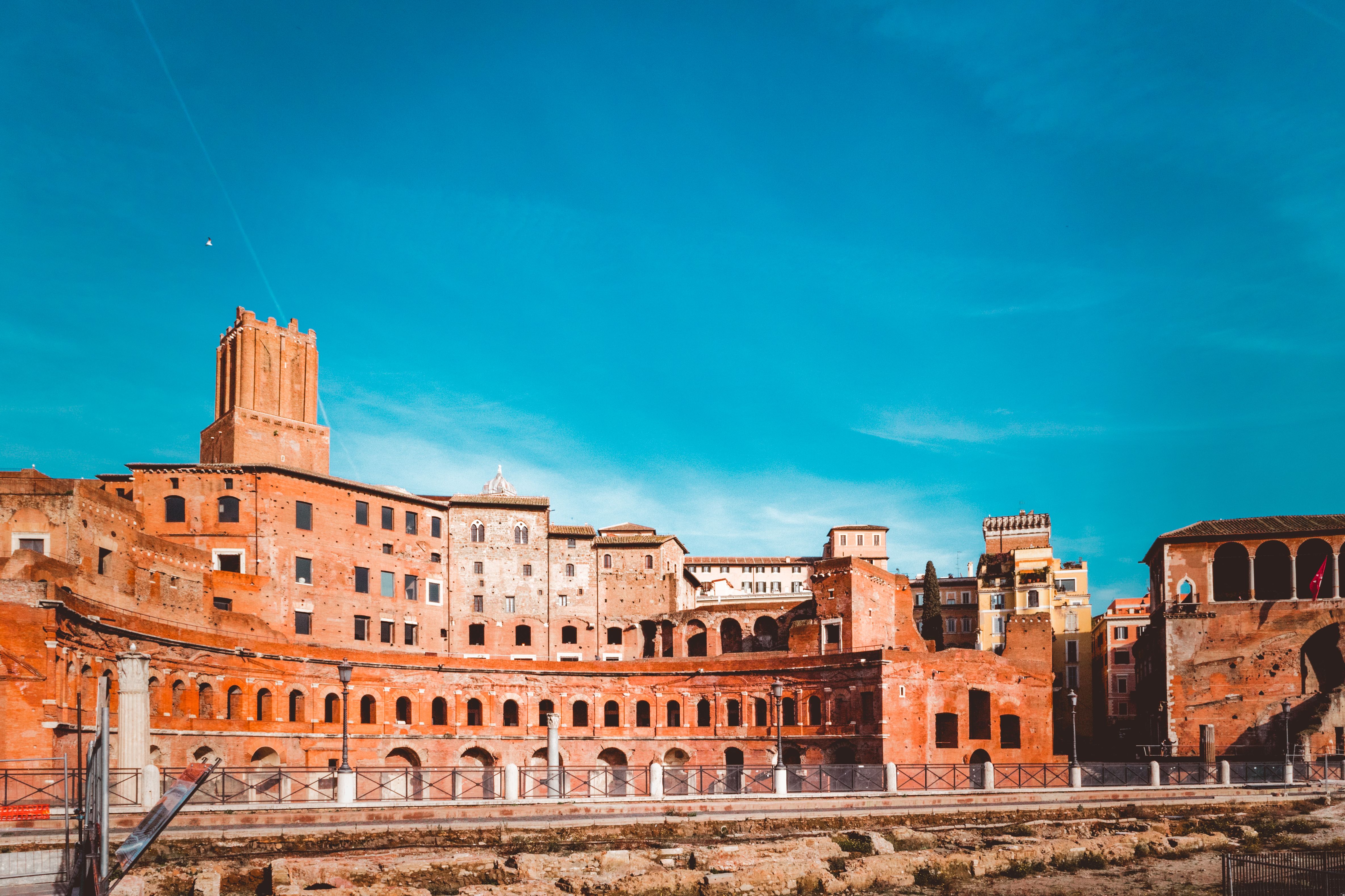 Ancient Trajan's Market in Rome with striking blue sky, showcasing historical architecture.