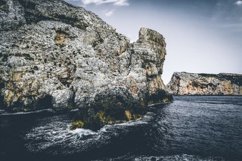 Free Breathtaking view of rugged cliffs along the Alghero coastline in Sardinia, Italy. Stock Photo