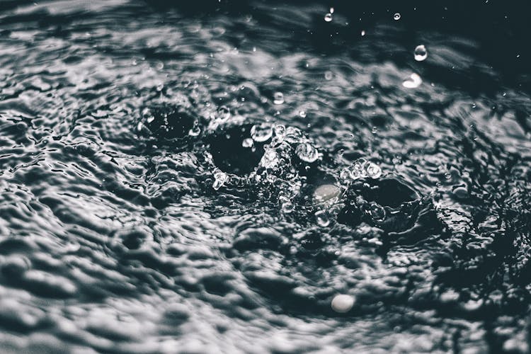 Close-up Of Drops Splashing On Water Surface