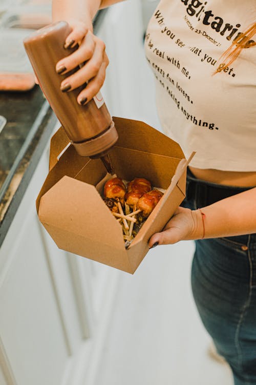 A Person Holding a Box with Food