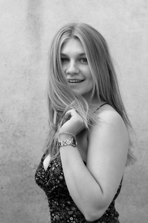 A Grayscale Photo of a Woman in Black Tank Top Smiling