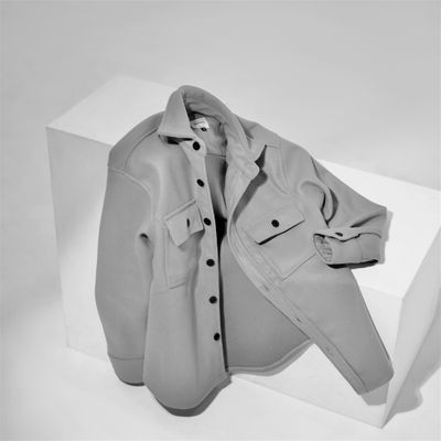 Grey shirt displayed on a white block — photo by Fahmi Garna on Pexels