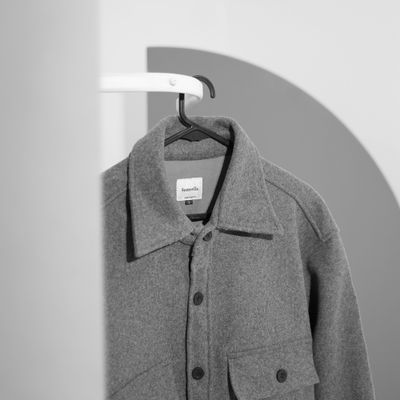 Grey jacket on a hanger — photo by Fahmi Garna on Pexels