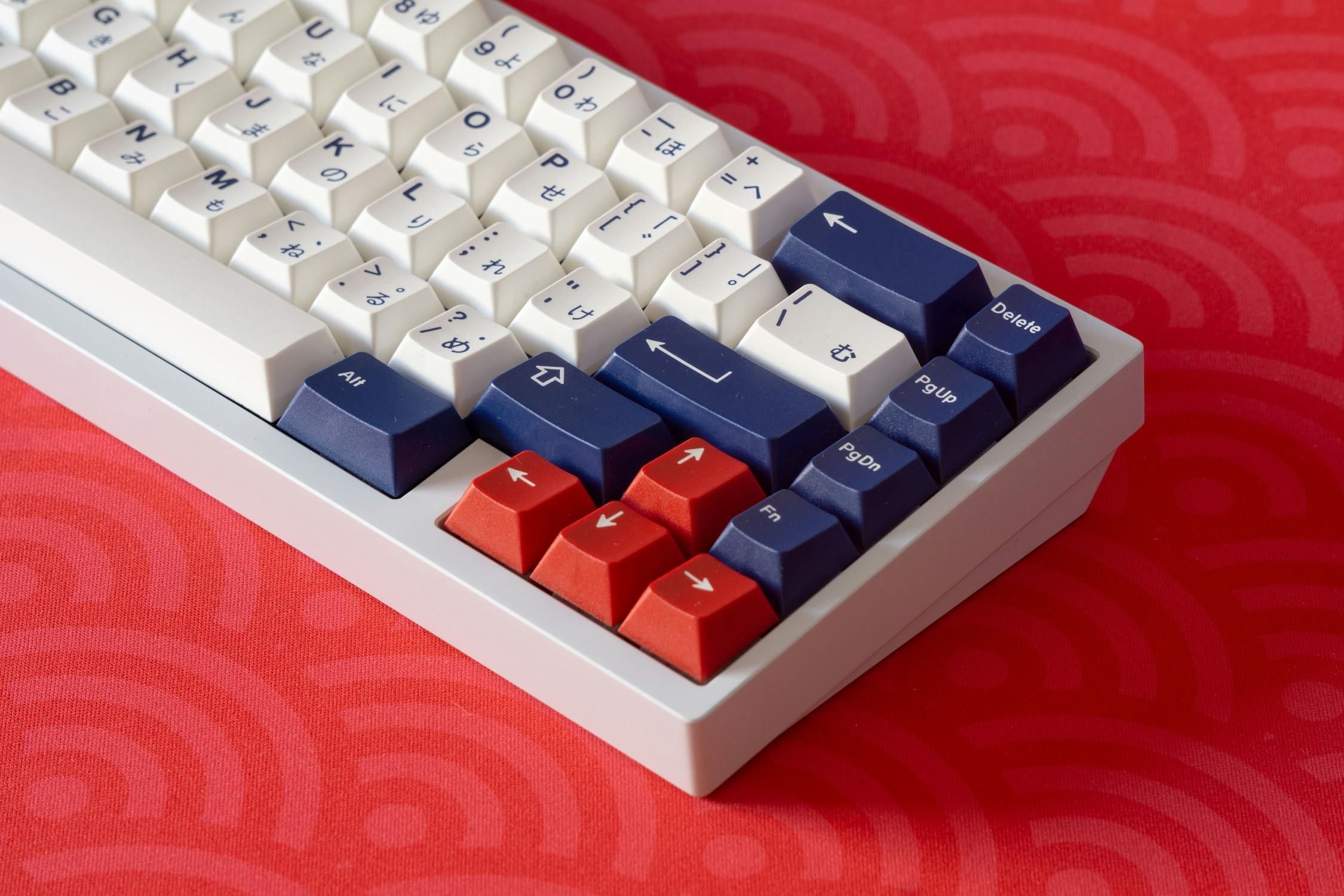Mechanical keyboard with white, blue, and red keycaps.