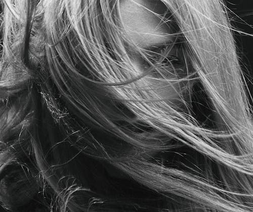 A Grayscale Photo of a Woman with Hair on Her Face