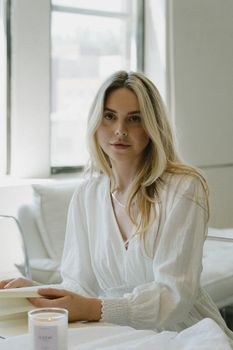 Beautiful Woman Sitting at Table with Book