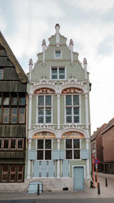 Detailed facade of a historic European building with decorative elements, showcasing classic architectural style.