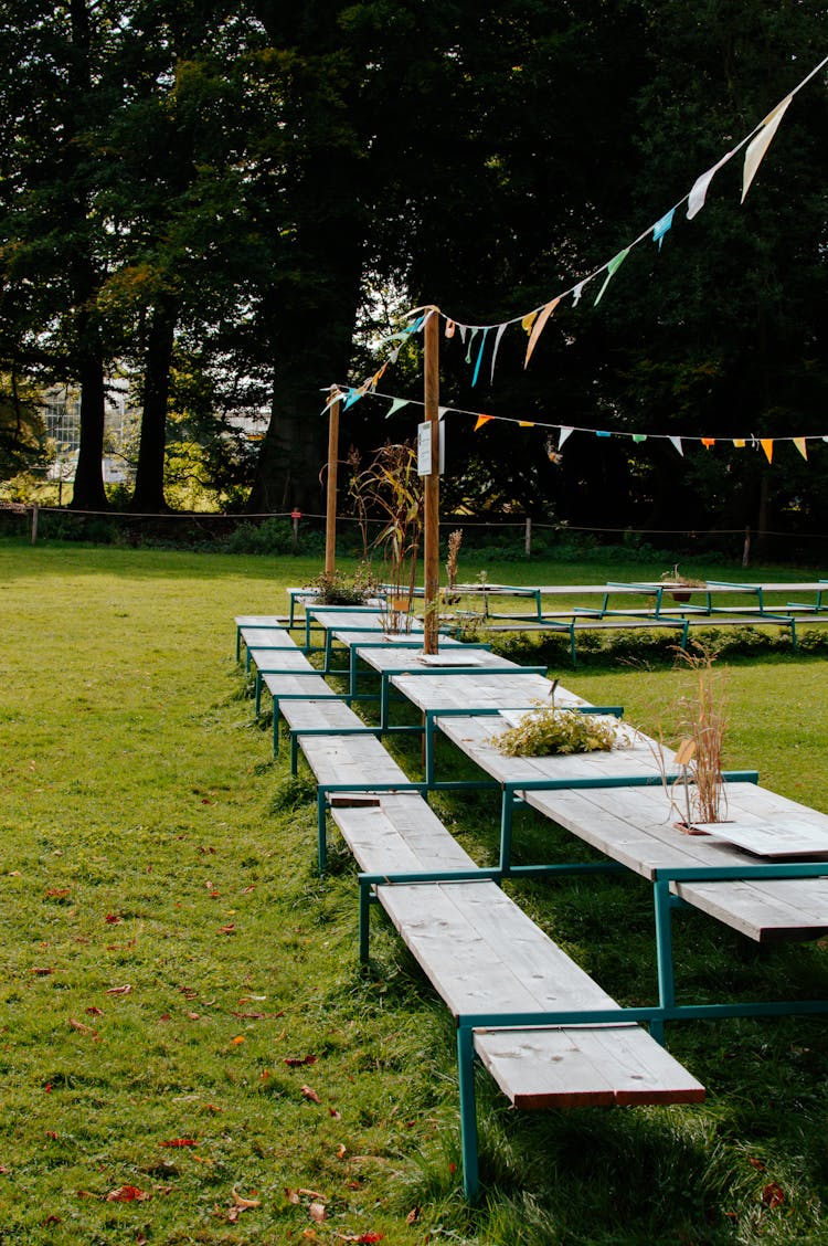 Wooden Picnic Table On Green Grass Field