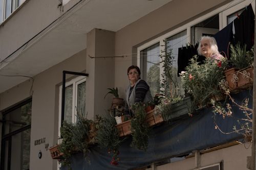 Free Two senior women enjoying a balcony view surrounded by potted plants in Istanbul. Stock Photo