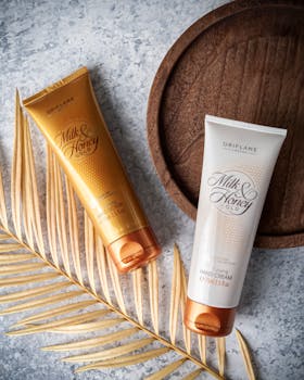 Luxurious hand creams and dried leaf on marble surface, perfect for premium skincare advertising.