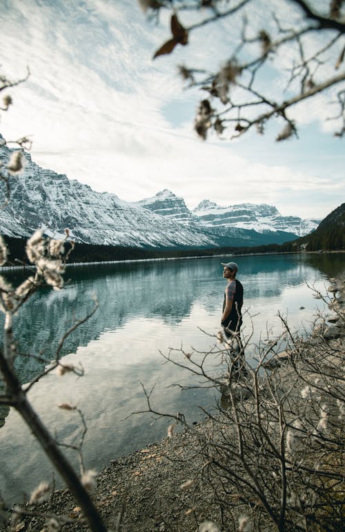 Man Standing by the Lake in the Banff National Park in Alberta, Canada 