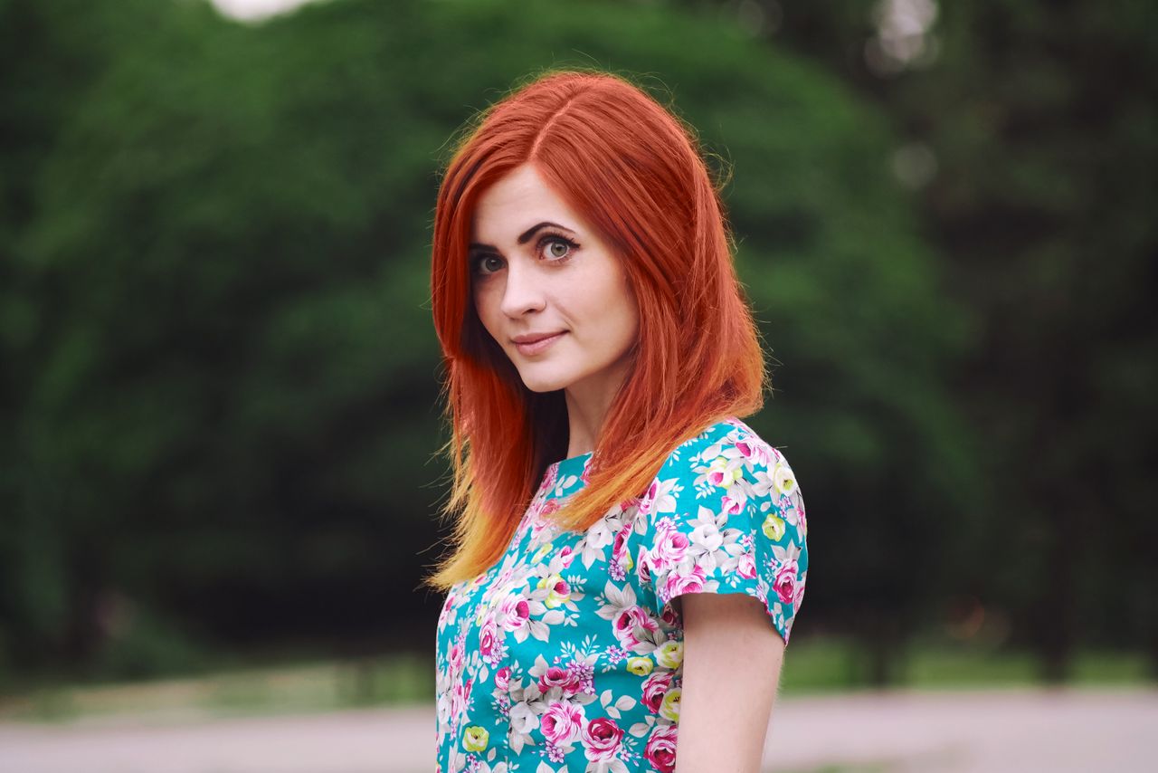 portrait of a redheaded woman with a floral top outdoors in kharkiv uk