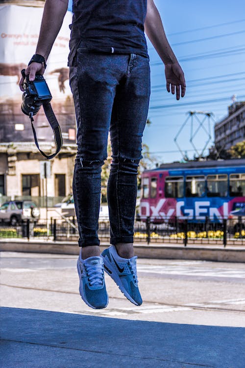 Person Jumping While Holding Camera