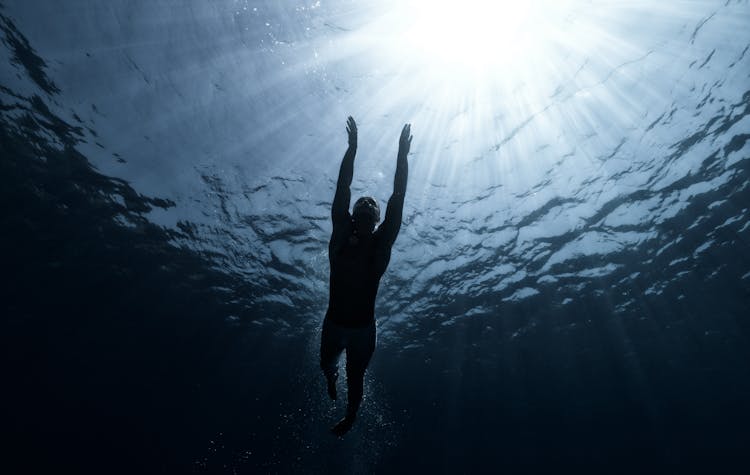 Low Angle Shot Of Man Swimming In The Sea