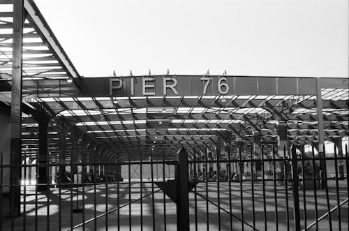 Grayscale Photo of the Signage of Pier 76
