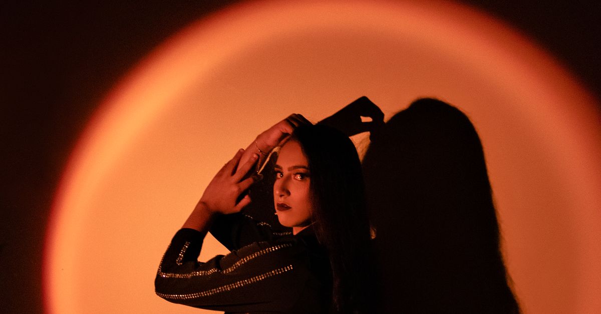 Near Shadow A Woman Posing Near Her Shadow · Free Stock Photo