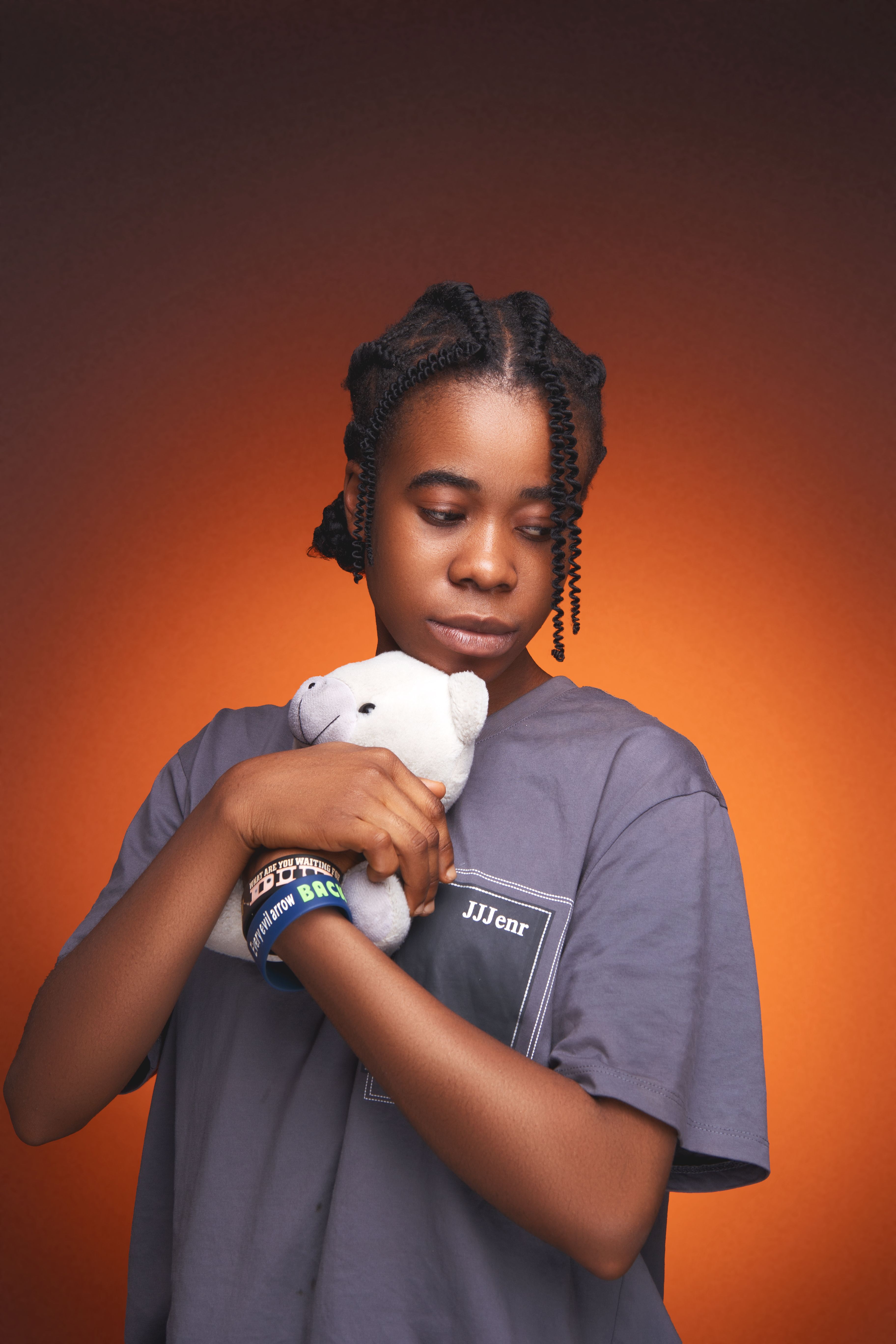 Peaceful portrait of a woman holding a plush toy with a vibrant background, expressing calmness.
