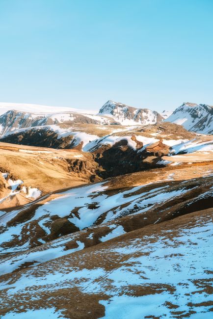 Breathtaking winter view of Icelandic snow-capped mountains under a clear blue sky.