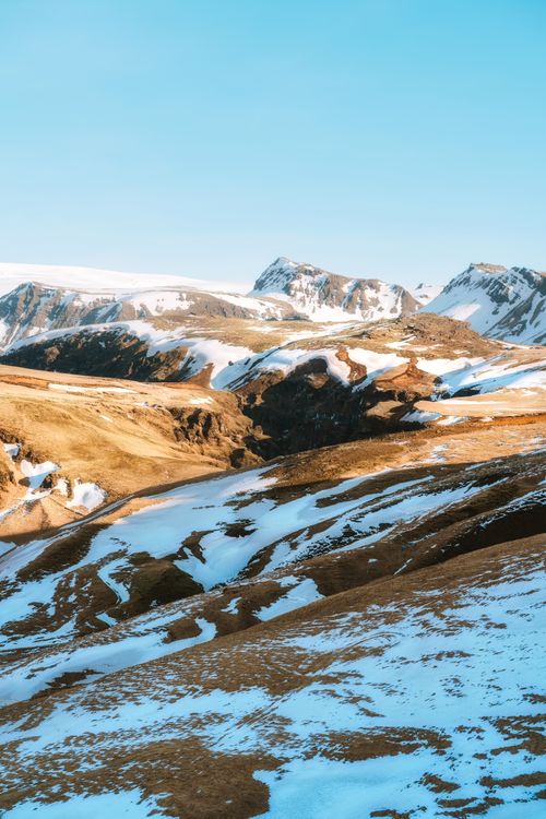 Free Breathtaking winter view of Icelandic snow-capped mountains under a clear blue sky. Stock Photo
