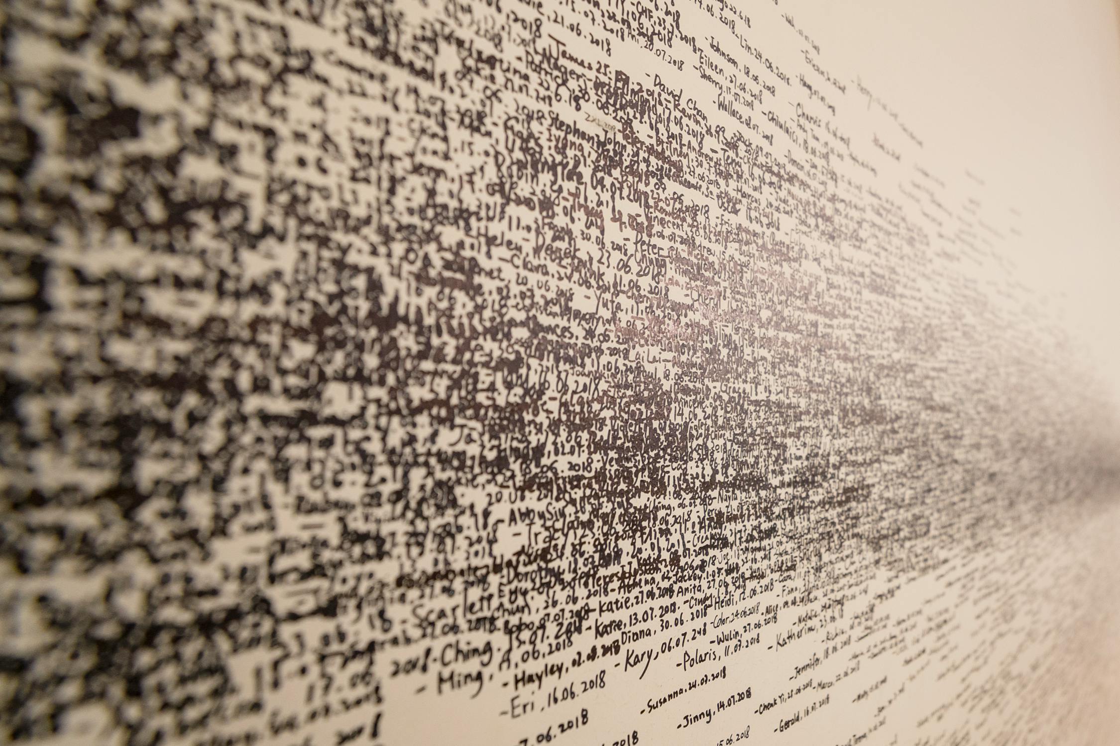 Image of complicated jumble of words written on a wall, depicting the challenge facing Natural Language Processing algorithms. 