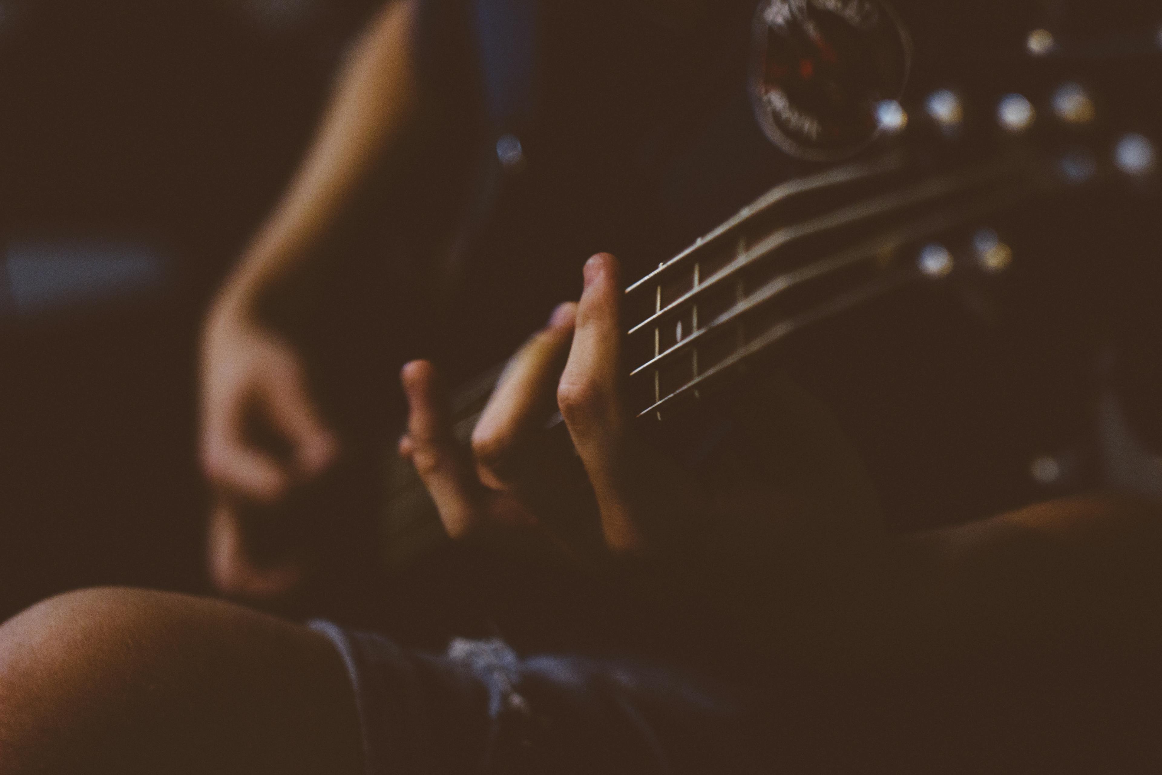 Person Playing Guitar