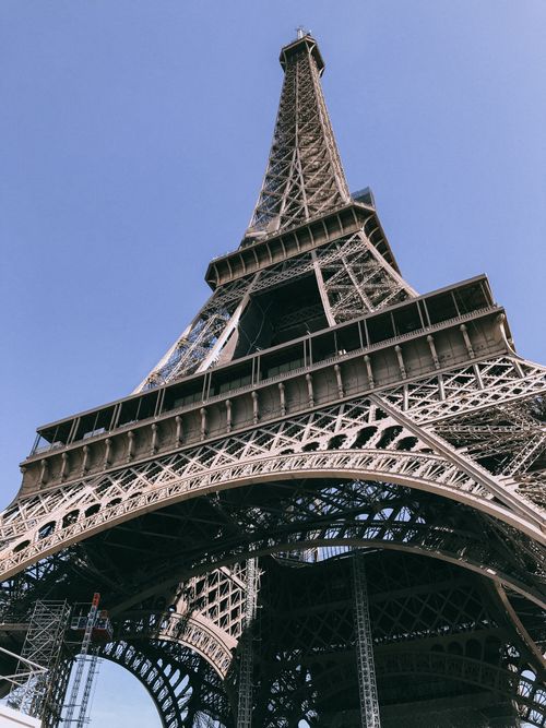 Free Low angle view of the iconic Eiffel Tower against a clear blue sky in Paris, France. Stock Photo