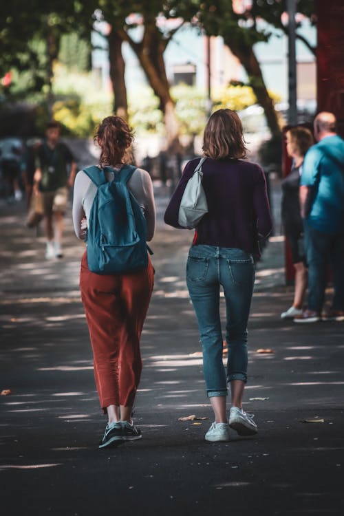 Foto profissional grátis de alforjes, andando, mulheres