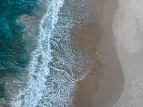 Free Spectacular aerial view of waves meeting the sandy shores of Currumbin Beach, Queensland, Australia. Stock Photo