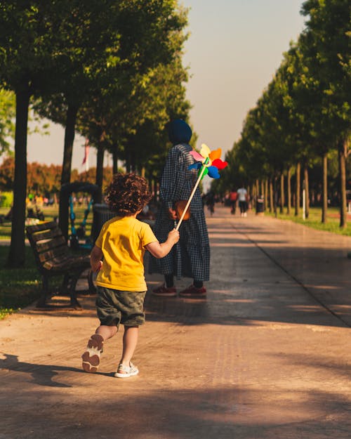 Back View of a Boy Running with a Toy