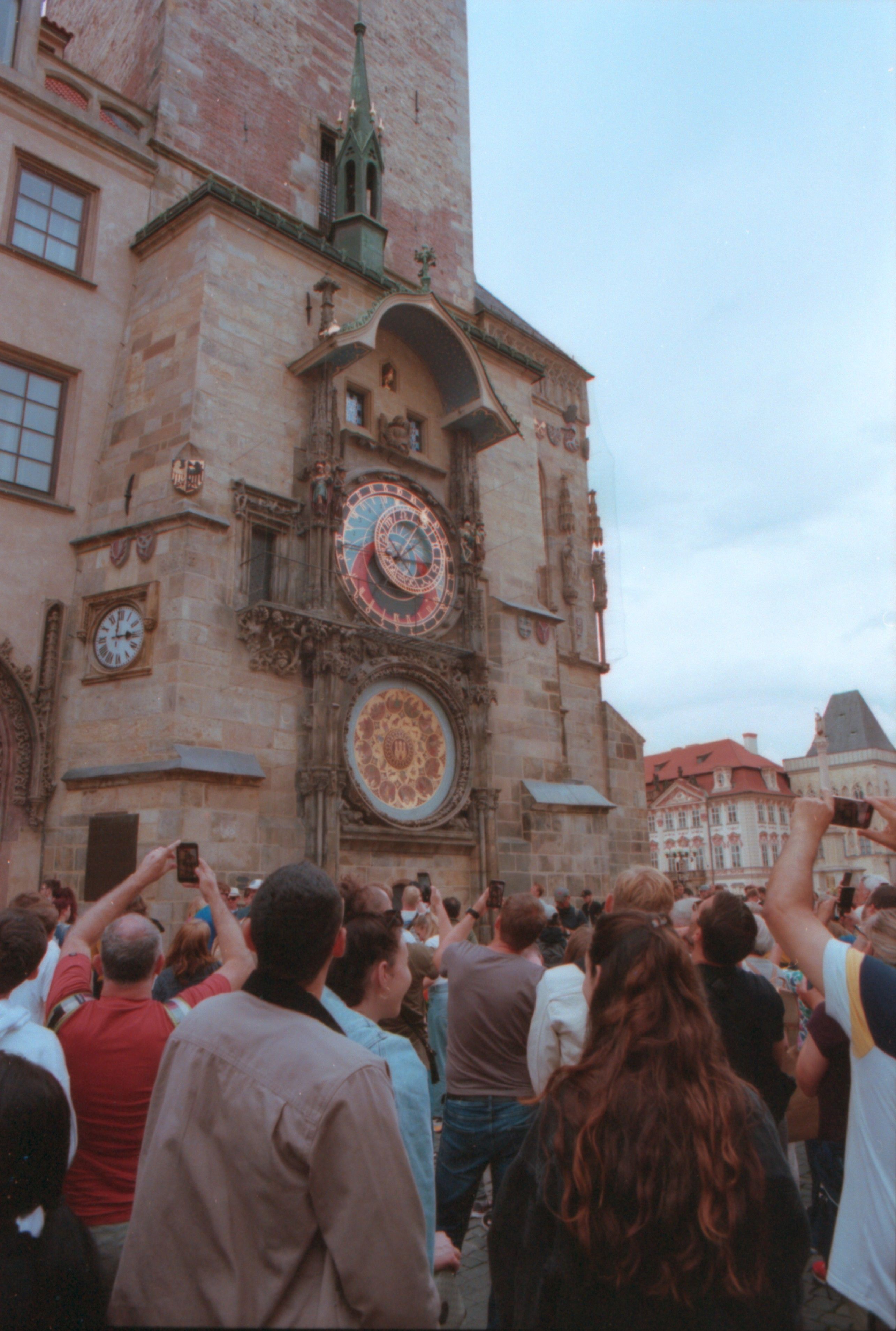 Crowd of tourists taking photos at the historic Prague Astronomical Clock.