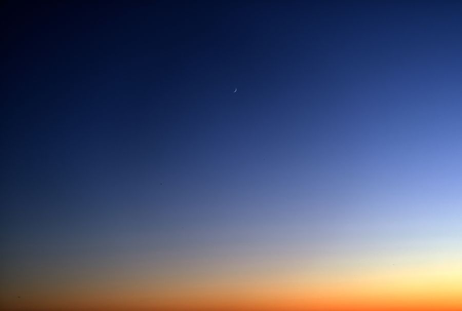 Beautiful twilight sky with a crescent moon and serene gradient of colors