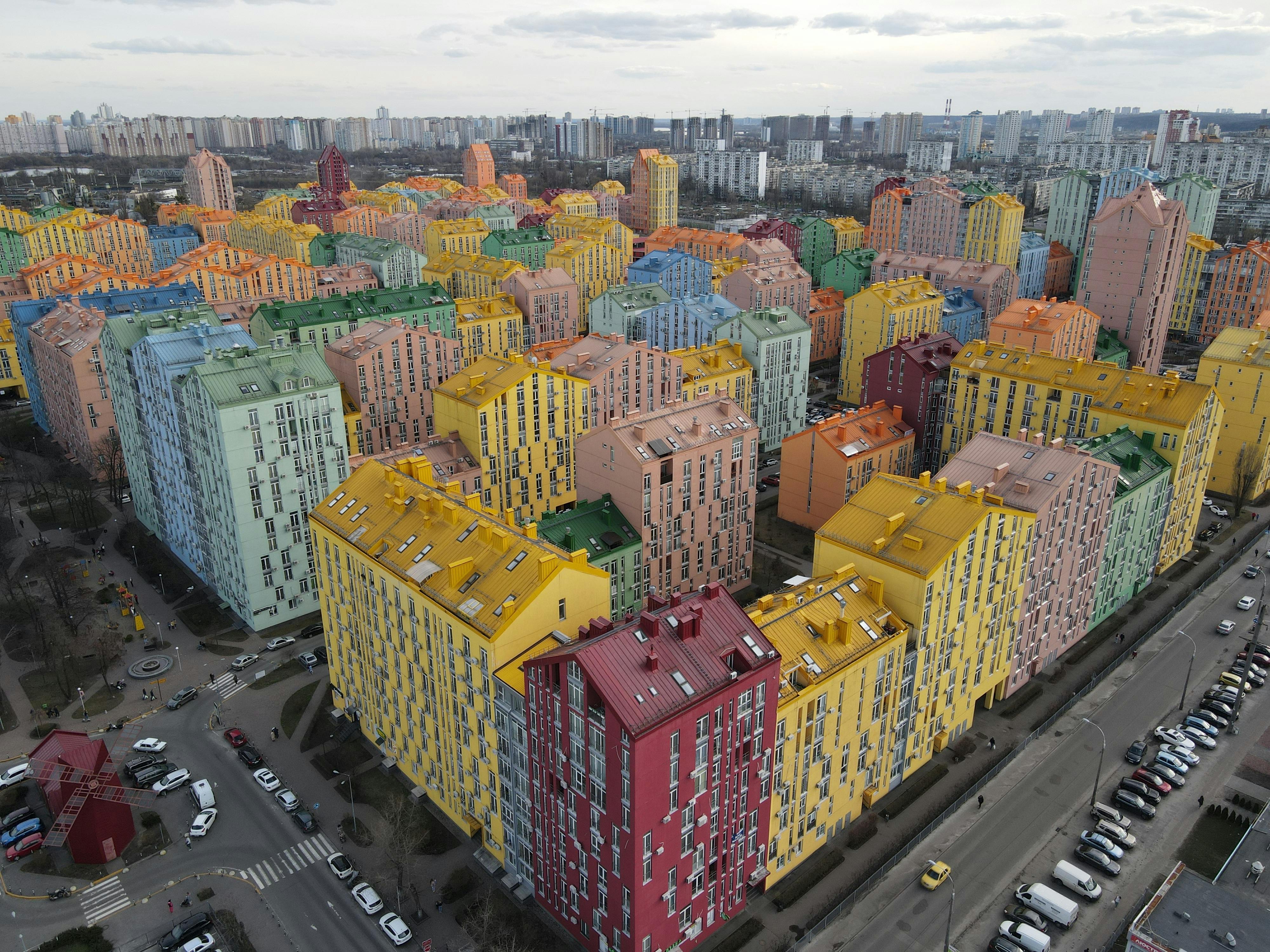 Aerial view of vibrant apartment complexes in Kyiv, showcasing colorful architecture.