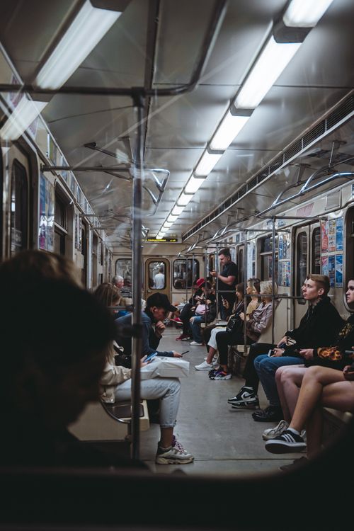 Free A diverse group of people sitting inside a city subway car during the day, showcasing urban public transportation. Stock Photo