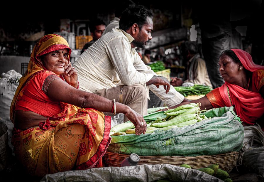 Vendors selling fresh vegetables at a rural market in India