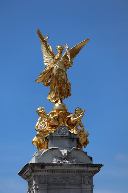 Gold Angel Statue Under Blue Sky